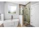 Luxurious bathroom featuring a standalone tub, glass-enclosed shower, and stylish tile work at 601 Lee St, Durham, NC 27701