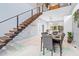 Open-concept dining area with modern staircase and view into the kitchen at 601 Lee St, Durham, NC 27701