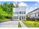 Modern home with a well-manicured lawn, professional landscaping, and a paved walkway at 601 Lee St, Durham, NC 27701