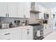 Contemporary kitchen with stainless steel appliances and white cabinetry at 601 Lee St, Durham, NC 27701