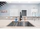 Close-up of a modern kitchen sink with a marble countertop and mosaic backsplash at 601 Lee St, Durham, NC 27701
