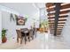Bright and airy living space with a dining area, open staircase, and large windows for natural light at 601 Lee St, Durham, NC 27701