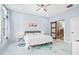 Bright main bedroom with a ceiling fan and bathroom with sliding glass door at 601 Lee St, Durham, NC 27701