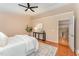 Inviting bedroom with a ceiling fan, hardwood floors, and a view of the staircase from doorway at 607 Palafox Dr, Chapel Hill, NC 27516