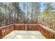 Wooden back deck surrounded by lush trees and greenery, offering serene outdoor space at 6715 Winding Arch Dr, Durham, NC 27713