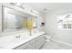 Bright bathroom featuring double sinks, a framed mirror, and a shower-tub combination at 6715 Winding Arch Dr, Durham, NC 27713