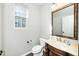 Cozy half-bathroom with tile floor, a decorative mirror, and a marble countertop sink at 6715 Winding Arch Dr, Durham, NC 27713