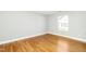 A serene bedroom featuring hardwood floors and a bright window for natural light at 6715 Winding Arch Dr, Durham, NC 27713