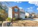 Side view of a two-story home with a brick facade and neutral siding on a sunny day at 6715 Winding Arch Dr, Durham, NC 27713