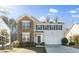 Charming two-story home featuring a brick facade, gray siding, and a two-car garage at 6715 Winding Arch Dr, Durham, NC 27713