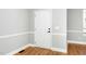 Entryway featuring a white door, hardwood floors, and neutral paint at 6715 Winding Arch Dr, Durham, NC 27713