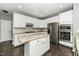 Modern kitchen with granite countertops, stainless steel appliances and a convenient center island at 6715 Winding Arch Dr, Durham, NC 27713