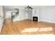Bright living room features a fireplace, hardwood floors, and a staircase to the second floor at 6715 Winding Arch Dr, Durham, NC 27713