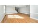 Open living room featuring hardwood floors, neutral paint, and stairs to the second floor at 6715 Winding Arch Dr, Durham, NC 27713