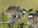 Aerial view of the house with an in-ground lawn sprinkler system and several outbuildings at 7055 Old 421 Rd, Liberty, NC 27298