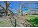 Backyard view of the house and barn with a fenced yard and mature trees at 7055 Old 421 Rd, Liberty, NC 27298