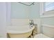 A stylish bathroom featuring a classic clawfoot tub and vintage-inspired fixtures at 7055 Old 421 Rd, Liberty, NC 27298