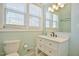 Bright bathroom with a white vanity, marble countertop, decorative mirror, and an abundance of natural light from the window at 7055 Old 421 Rd, Liberty, NC 27298