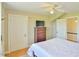 Bedroom features a wooden dresser, ceiling fan, and easy access to other areas of the home at 7055 Old 421 Rd, Liberty, NC 27298