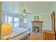 Charming bedroom with a brick fireplace, hardwood floors, and a cozy quilt at 7055 Old 421 Rd, Liberty, NC 27298