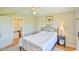Cozy bedroom features a ceiling fan, artwork, and access to the hallway, offering comfort and convenience at 7055 Old 421 Rd, Liberty, NC 27298