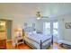 Bright bedroom featuring a large window, ceiling fan and hardwood floors at 7055 Old 421 Rd, Liberty, NC 27298