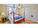 Comfortable bedroom featuring windows, hardwood floors, and a ceiling fan creating a serene atmosphere at 7055 Old 421 Rd, Liberty, NC 27298