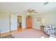 Comfortable bonus room includes hardwood floors, a ceiling fan and access to other areas of the home at 7055 Old 421 Rd, Liberty, NC 27298