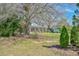 Beautiful home with a welcoming front porch, complemented by mature trees and a convenient carport at 7055 Old 421 Rd, Liberty, NC 27298