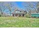Lovely brick farmhouse with cozy front porch and mature shade trees at 7055 Old 421 Rd, Liberty, NC 27298