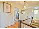 Hallway featuring wood floors, white walls, and transom window views at 7055 Old 421 Rd, Liberty, NC 27298