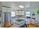 Bright kitchen with white cabinets, granite countertops, stainless steel appliances, and central island at 7055 Old 421 Rd, Liberty, NC 27298