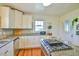 Kitchen featuring white cabinets, granite countertops and stainless steel appliances at 7055 Old 421 Rd, Liberty, NC 27298