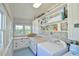 Laundry room with exposed brick and white shelving for storage at 7055 Old 421 Rd, Liberty, NC 27298