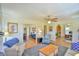 Inviting living room with a ceiling fan, wood floors, and an open layout to the dining room and office at 7055 Old 421 Rd, Liberty, NC 27298
