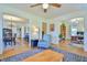 Open-concept layout with a living room, dining area with chandelier, and office space with shelving at 7055 Old 421 Rd, Liberty, NC 27298