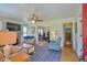 Bright living room with hardwood floors, a fireplace, and views into the dining room at 7055 Old 421 Rd, Liberty, NC 27298