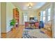 Bright home office with hardwood floors, built-in shelving, and a spacious desk area at 7055 Old 421 Rd, Liberty, NC 27298