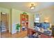 Well-lit office space with hardwood floors, a built-in bookcase, and large windows at 7055 Old 421 Rd, Liberty, NC 27298