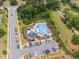 Aerial image of the community pool and parking lot with nearby trees and landscaping at 706 Tibumoll Ln, Fuquay Varina, NC 27526