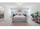 Spacious primary bedroom with neutral decor, bedside tables, and twin windows creating a serene and inviting atmosphere at 706 Tibumoll Ln, Fuquay Varina, NC 27526