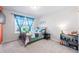 Comfortable bedroom features a large window, blue decor, and a plush bed at 706 Tibumoll Ln, Fuquay Varina, NC 27526
