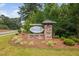Neighborhood entrance sign displaying a stone base, landscaping, and a manicured lawn at 706 Tibumoll Ln, Fuquay Varina, NC 27526