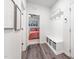 Inviting entryway featuring a convenient mudroom bench with coat hooks and storage baskets, seamlessly connecting to a cozy bedroom at 706 Tibumoll Ln, Fuquay Varina, NC 27526