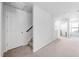 Upstairs hallway featuring access to an additional room and a linen closet at 706 Tibumoll Ln, Fuquay Varina, NC 27526