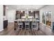 Spacious kitchen featuring dark wood cabinets, granite countertops, stainless steel appliances, and a large center island at 706 Tibumoll Ln, Fuquay Varina, NC 27526