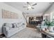 Cozy living room featuring a comfortable sofa, modern decor, and an open view to the kitchen at 706 Tibumoll Ln, Fuquay Varina, NC 27526