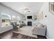 Bright living room features a fireplace, built-in shelving, and large windows that provide natural light at 706 Tibumoll Ln, Fuquay Varina, NC 27526