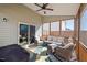 Cozy screened porch featuring comfortable seating, ceiling fan, and an inviting atmosphere for relaxation at 706 Tibumoll Ln, Fuquay Varina, NC 27526