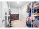 Spacious walk-in closet featuring wire shelving and a built-in dresser, offering ample storage and organization solutions at 706 Tibumoll Ln, Fuquay Varina, NC 27526